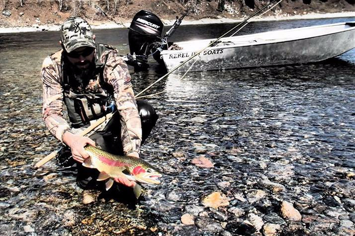 Rebel jet boat fly fisherman on the rocks
