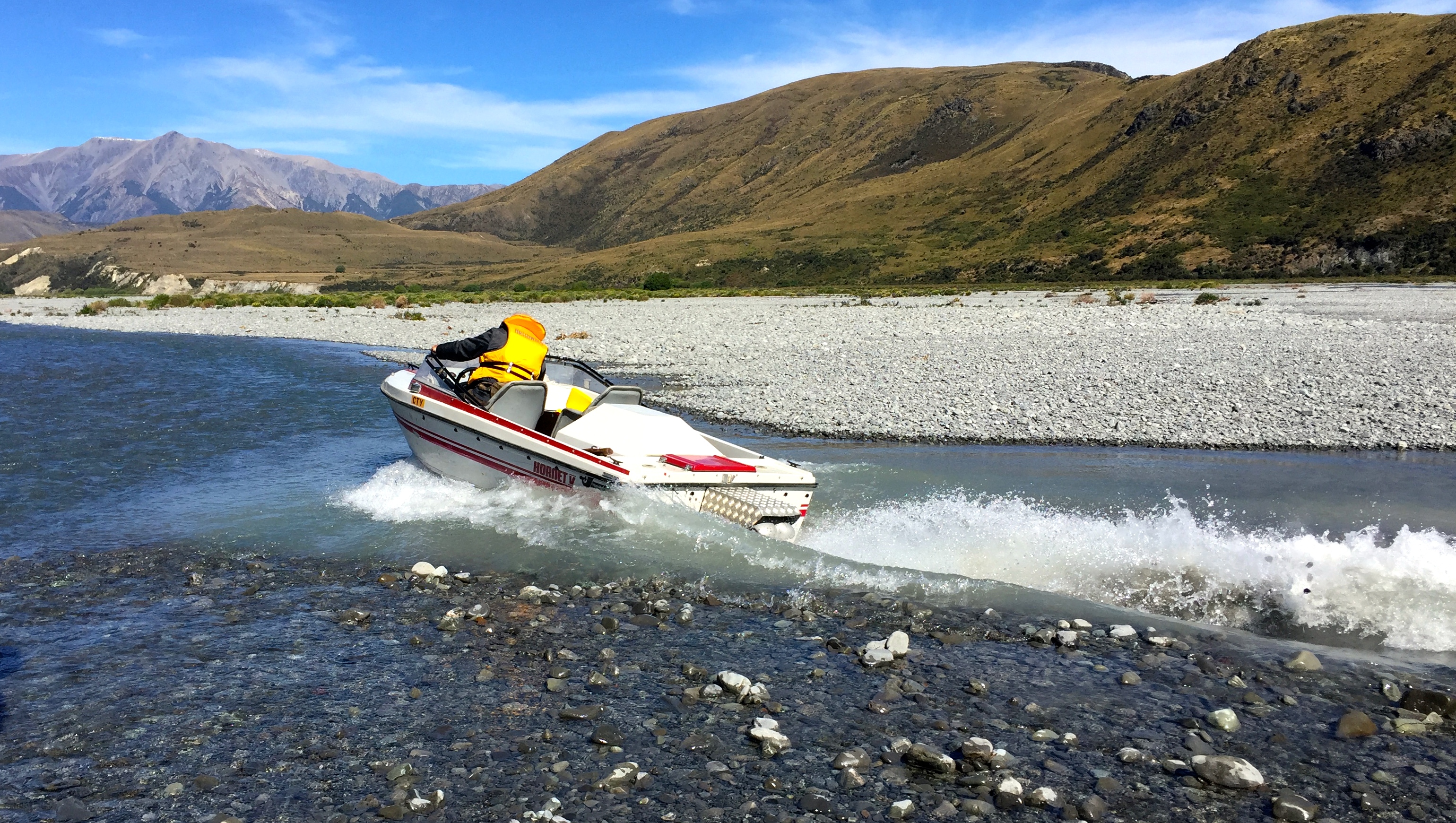 Wetlander Jet Boat going through rocky shallow water